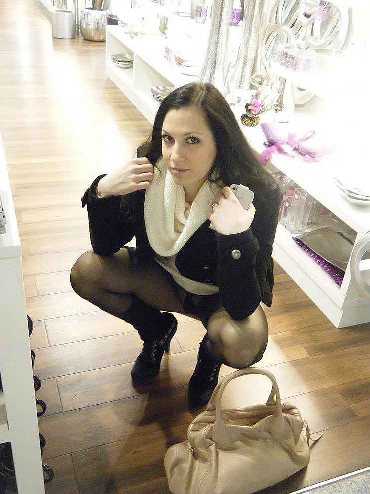 Immoral amateur girl lifts up her scirt to show ass and legs in black pantyhose in the supermarket