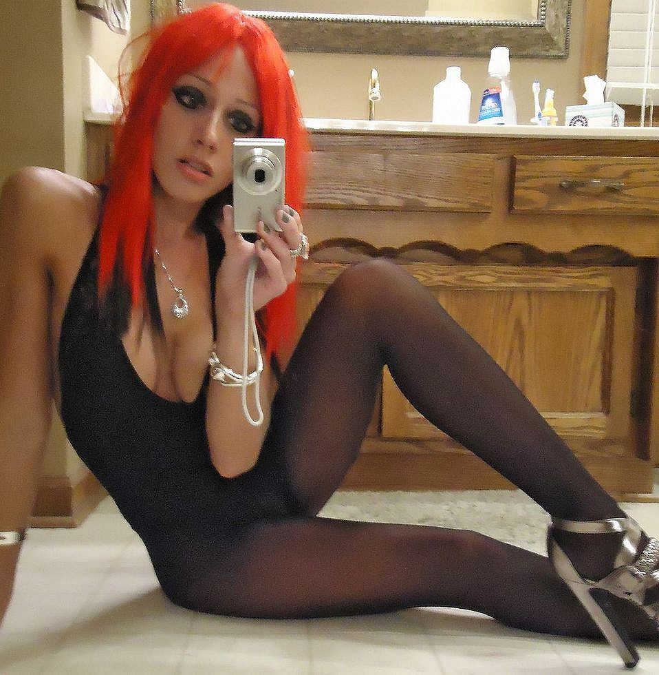 Girl in pantyhose takes a selfie before mirror